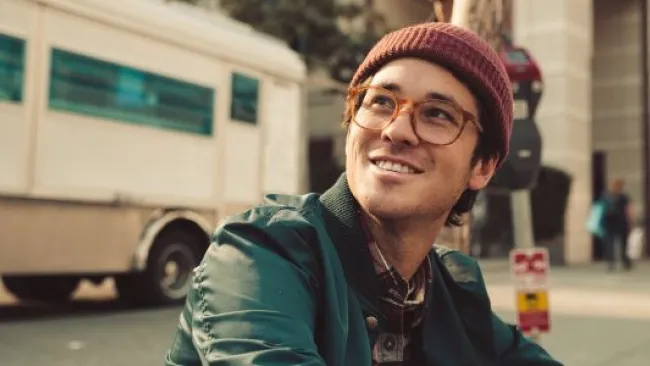 A guy on the street smiling