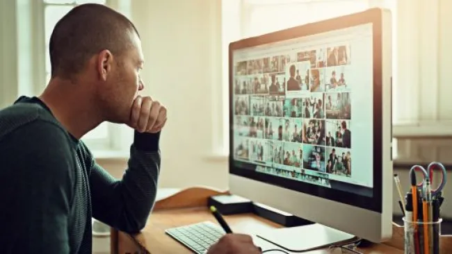 A man looking at his monitor