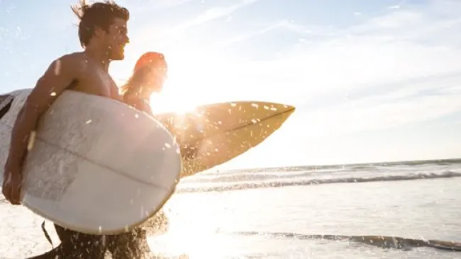 Two surfers on the shore