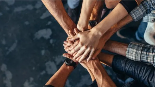 Team joining hands together