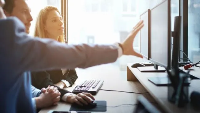 People discussing something at their workstation