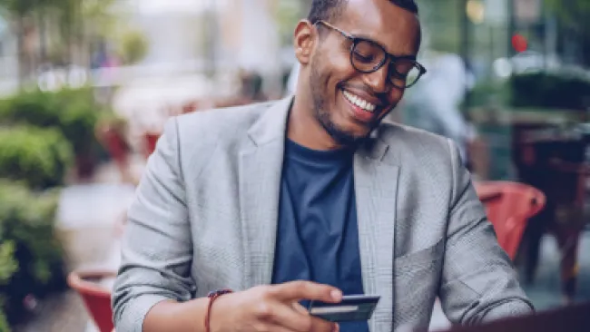 A man holding a credit card