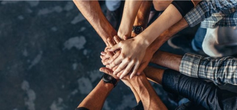 Team joining hands together