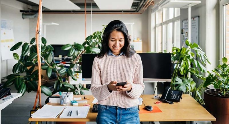A woman at her workstation looking happy