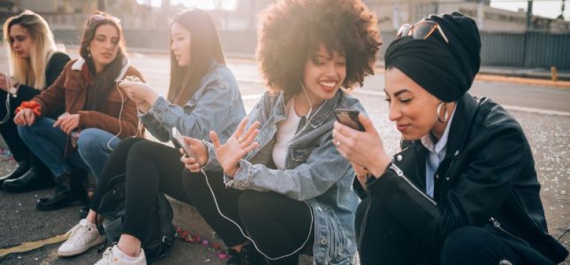 Ladies sitting on the pavement