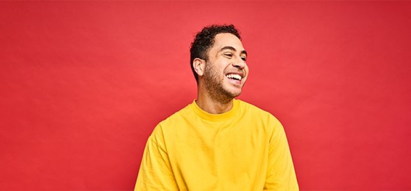 A happy man wearing a yellow shirt