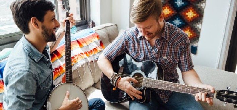 2 men playing guitar