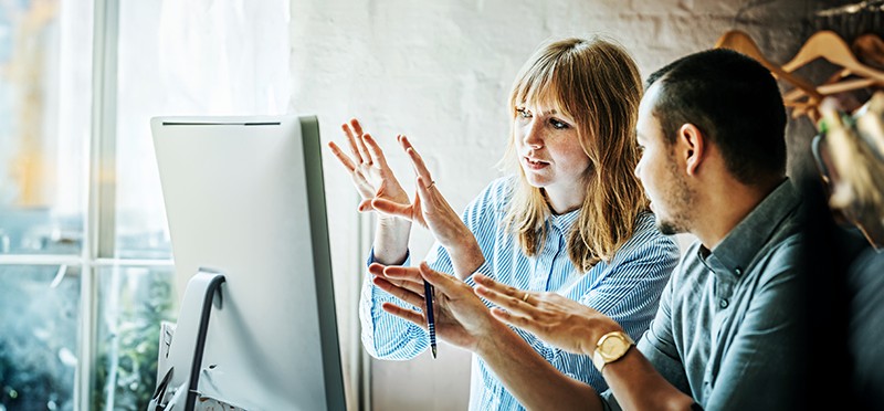 Woman and man looking at a computer screen.